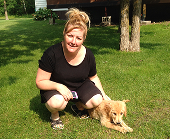 outdoor photo of woman with a golden retriever puppy