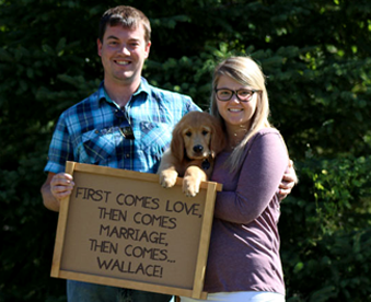 outdoor photo of a couple holding a golden retriever puppy and a Gotcha Day sign